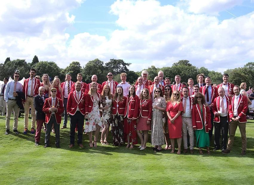 Kingston Rowing Club members standing on Remenham Club lawn at Henley Royal Regatta